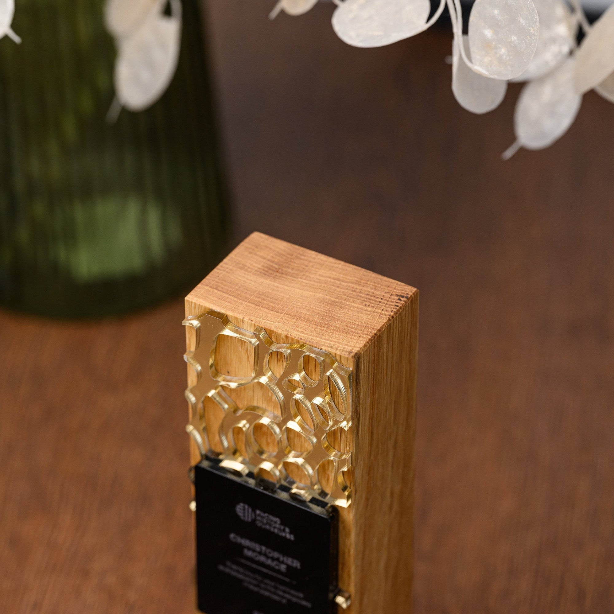 Top-down view of the award showing the oak end grain and the gold acrylic overlay on the front face