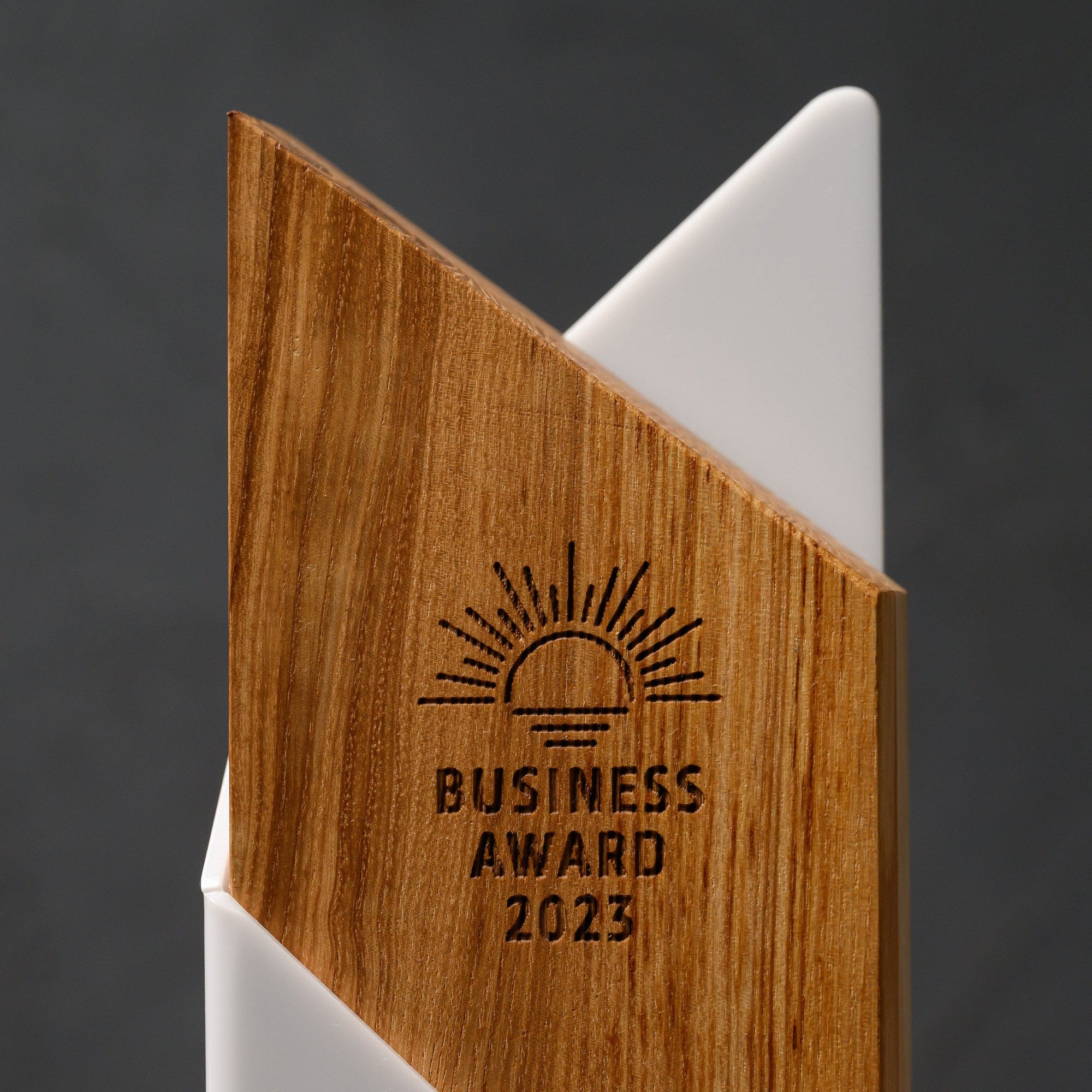 Macro of the laser-engraved emblem and wording cut into the oak face