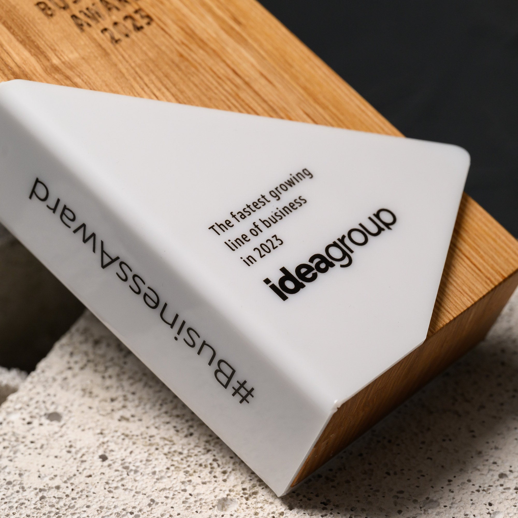 Overhead close-up of the acrylic panel with printed text running along its folded edge