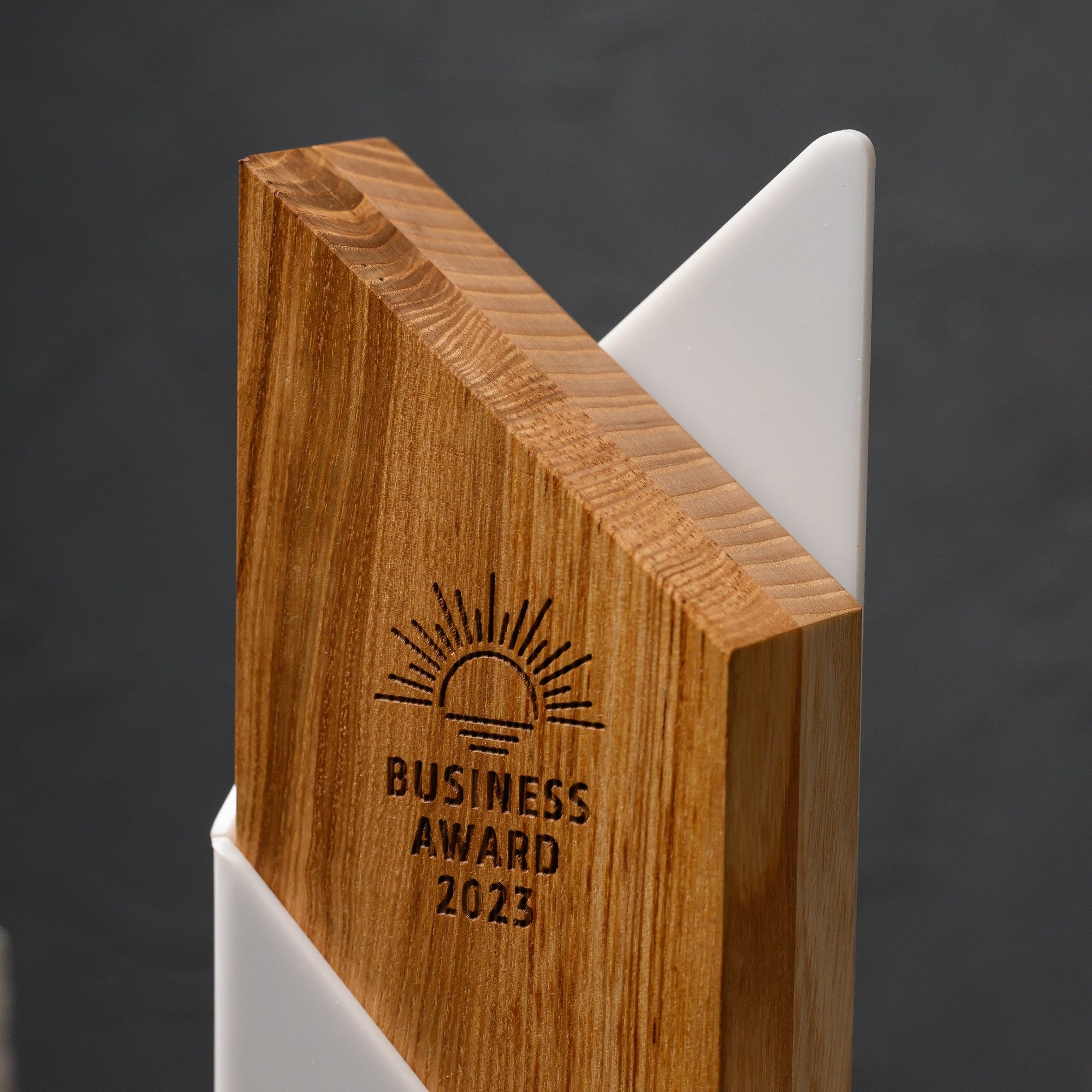 Top of the award where the oak edge and the pointed white acrylic panel meet