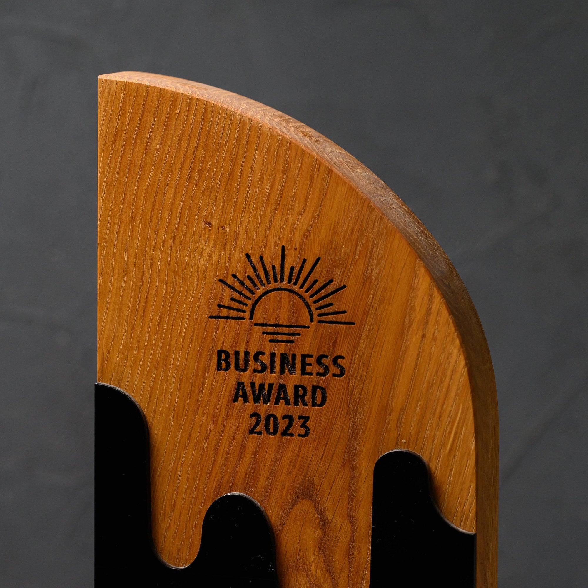 Upper oak section with a laser-engraved emblem and award wording above the wave-cut edge