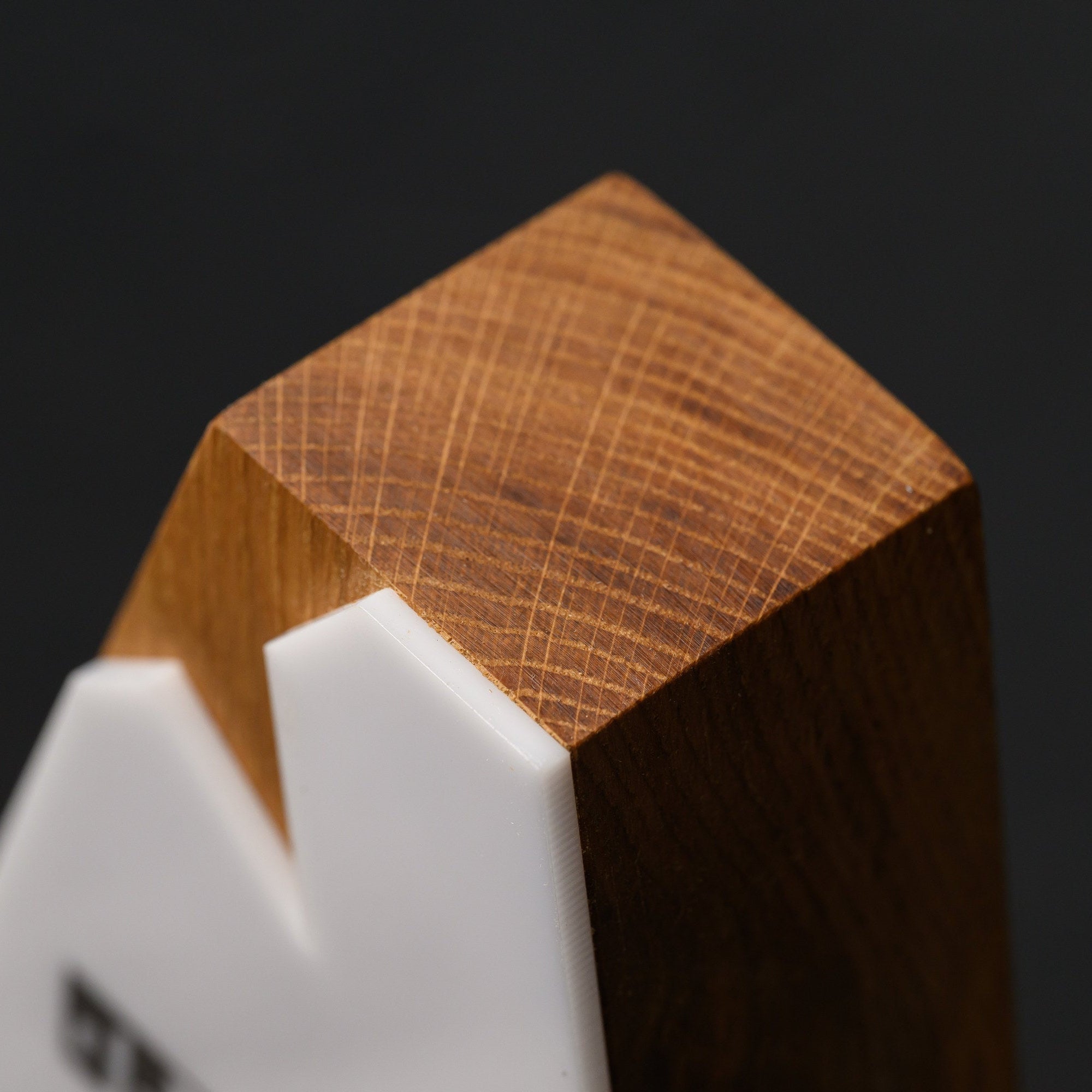Apex of the award showing the oak end grain above the white acrylic peak