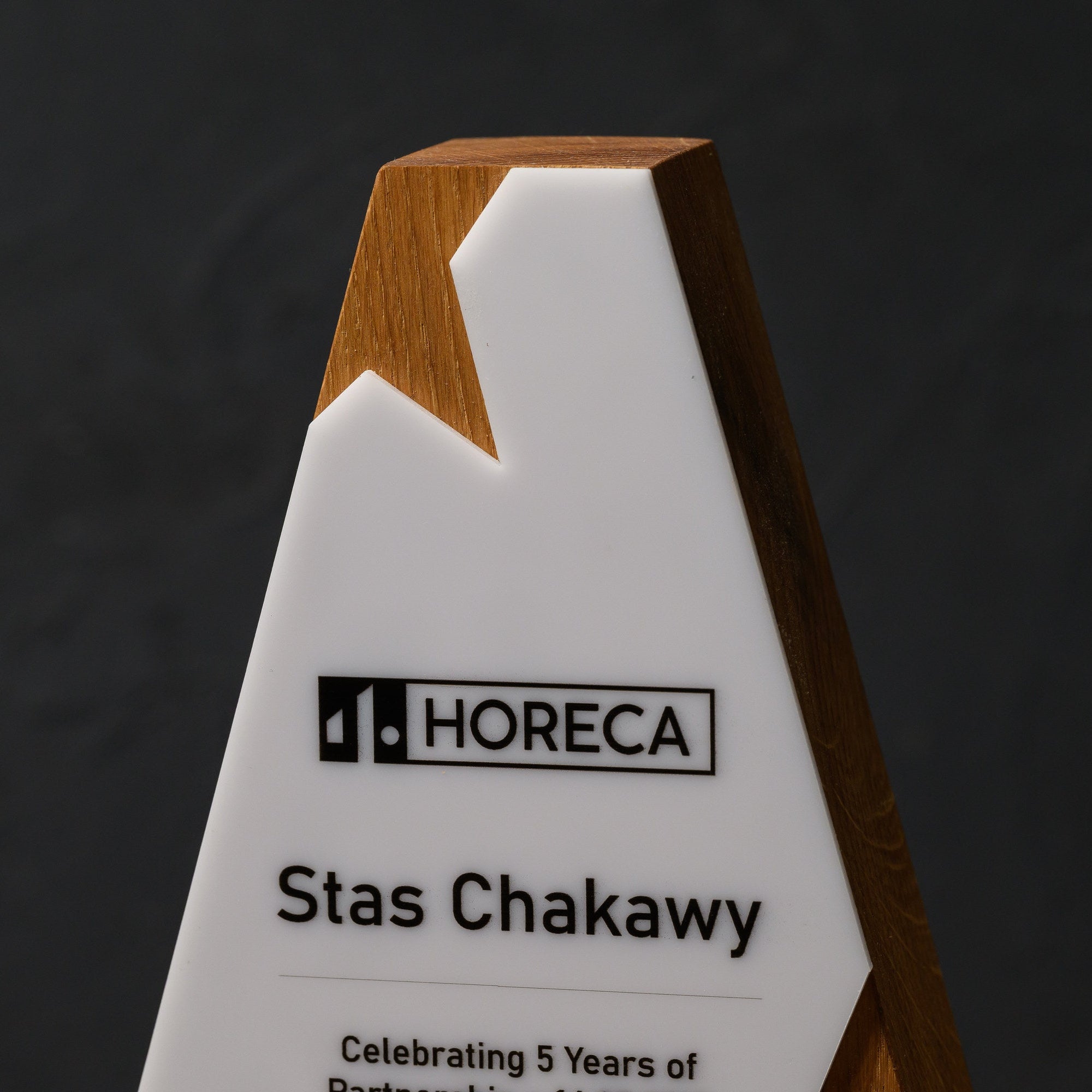 Upper section of the award where the acrylic peak notches into the tapering oak body