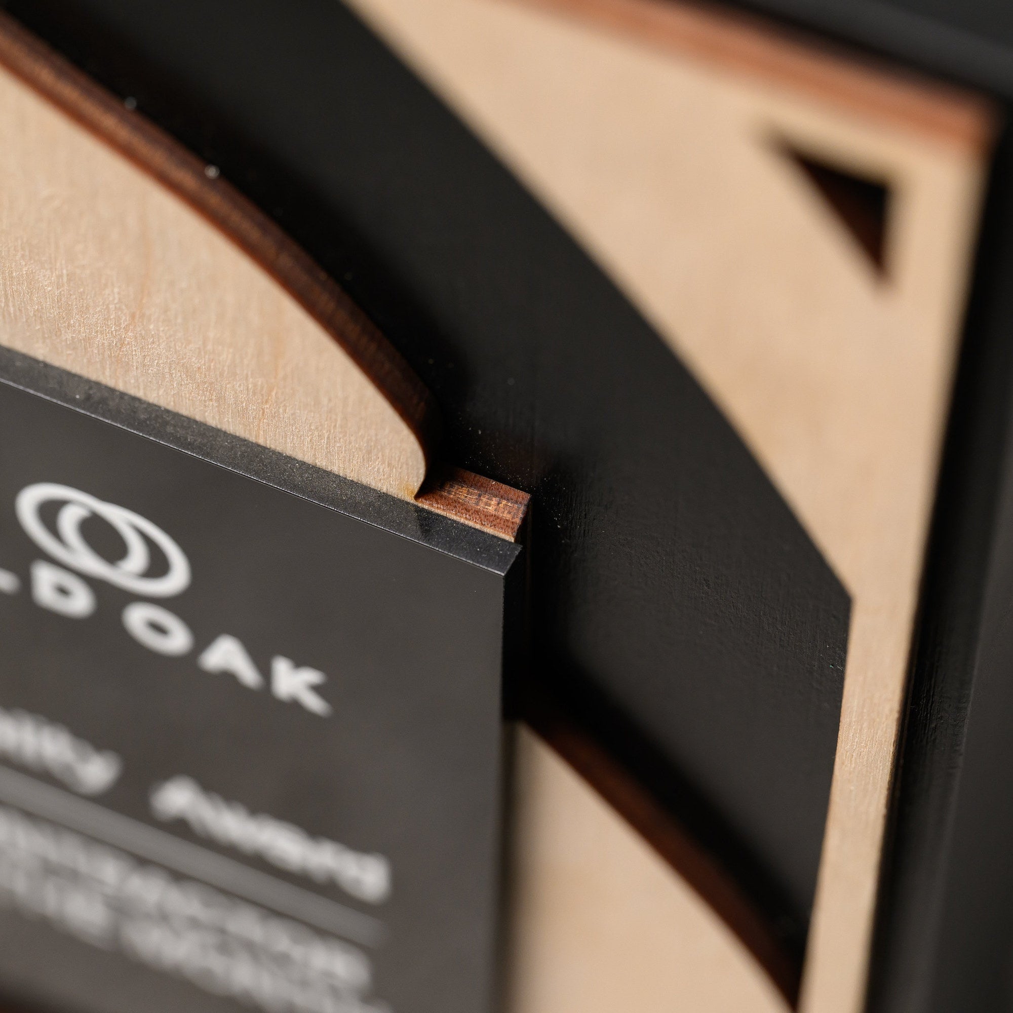 Detail of the acrylic plate corner where it slots against the cut plywood and the wood edge