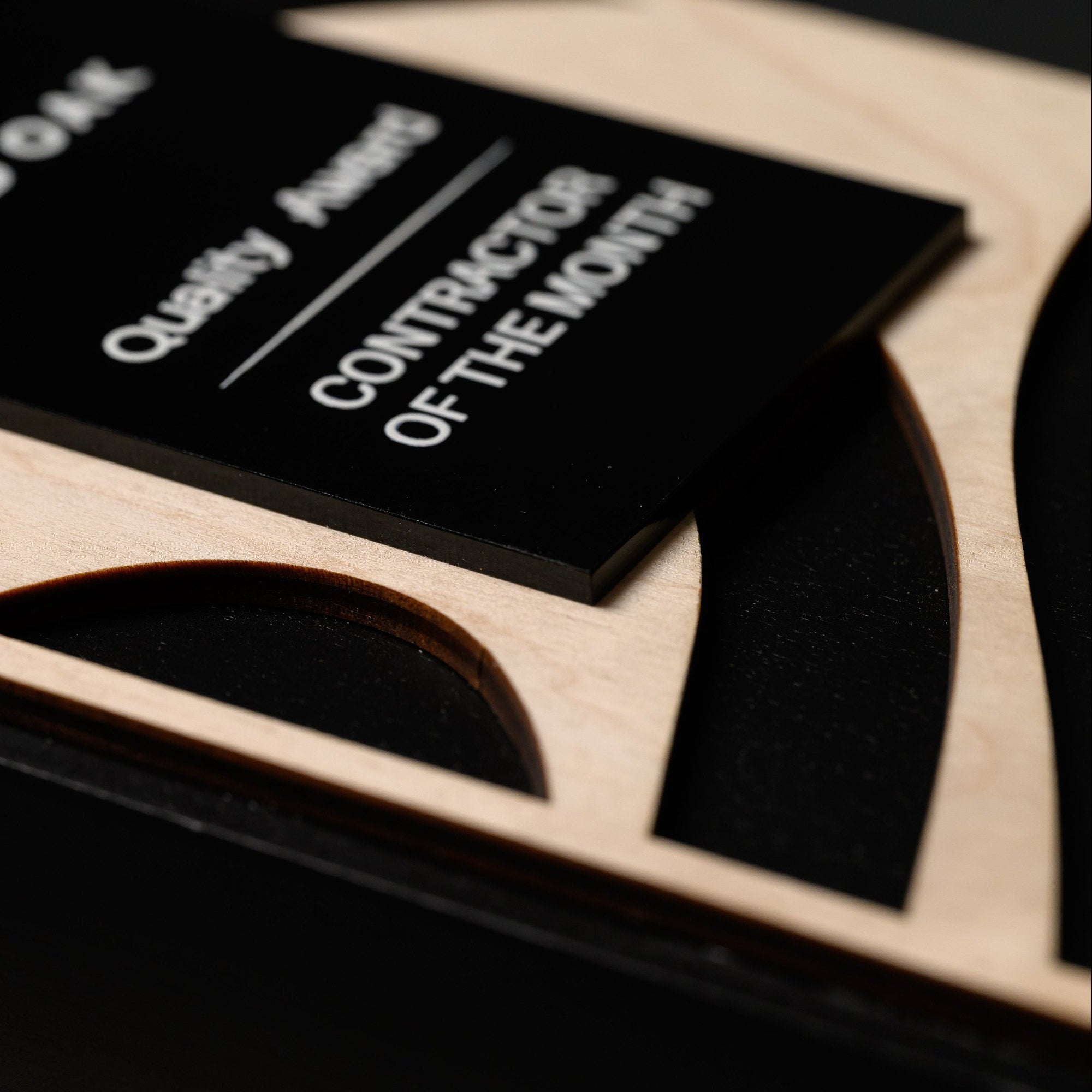 Macro of the UV printed acrylic plate showing white lettering and the polished cut edge