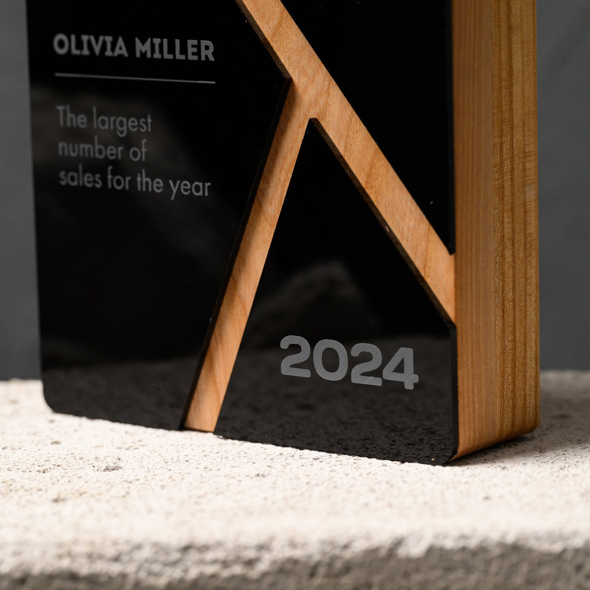 Base of the award where the oak strut meets the engraved year on the black acrylic