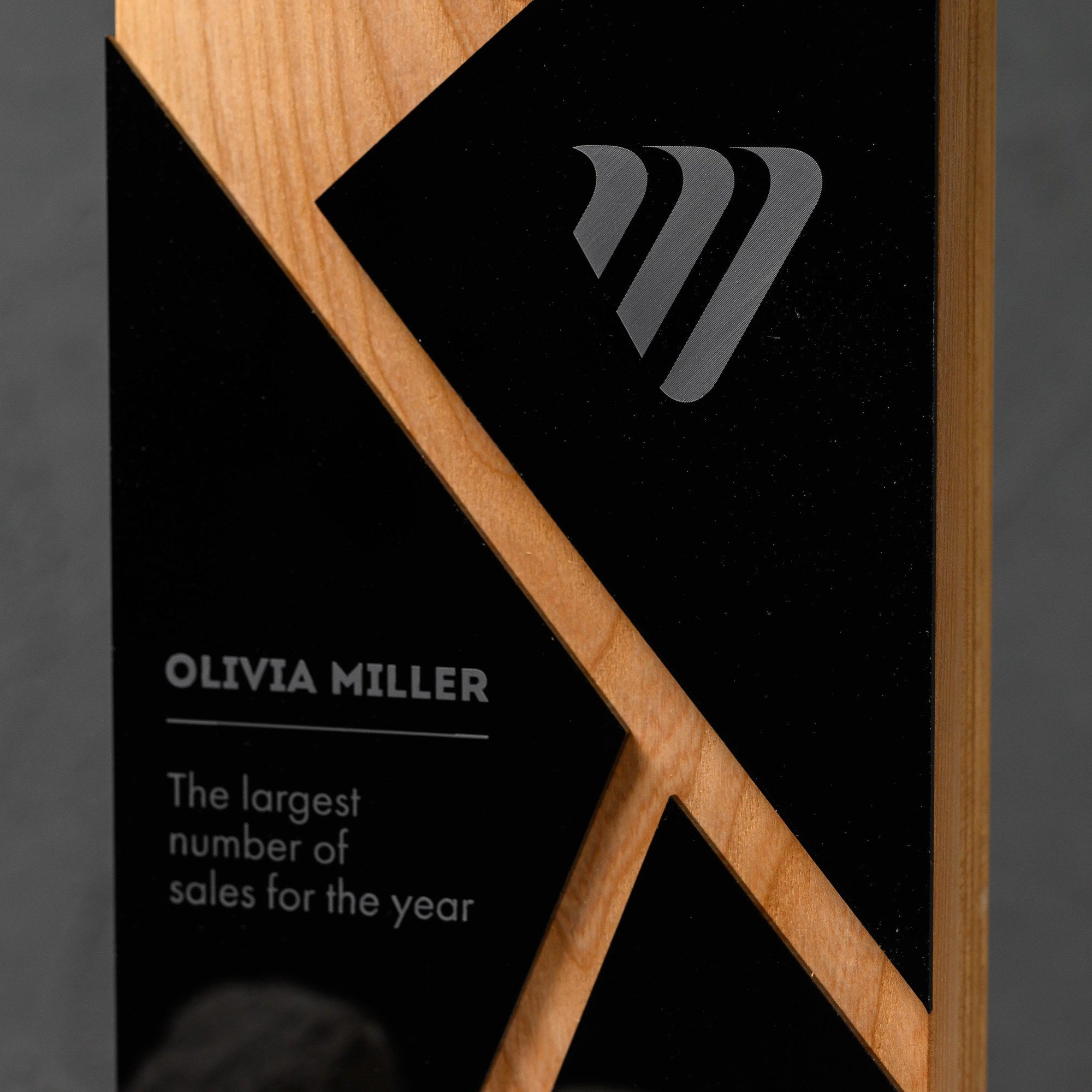 Upper panel with an engraved emblem, winner name and citation beside the oak diagonal