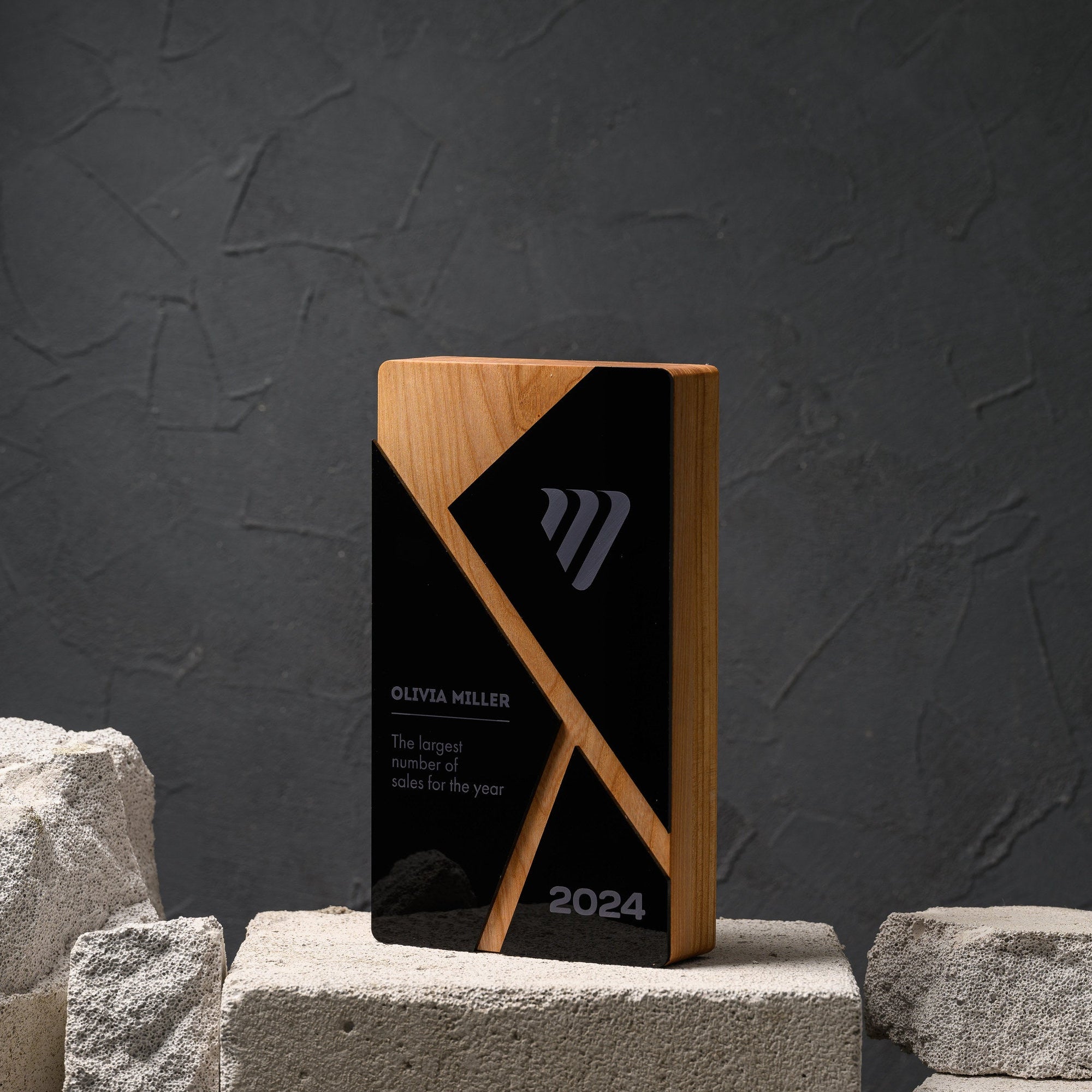 Oak award with a diagonal inlay crossing an inset black acrylic panel, on a stone plinth