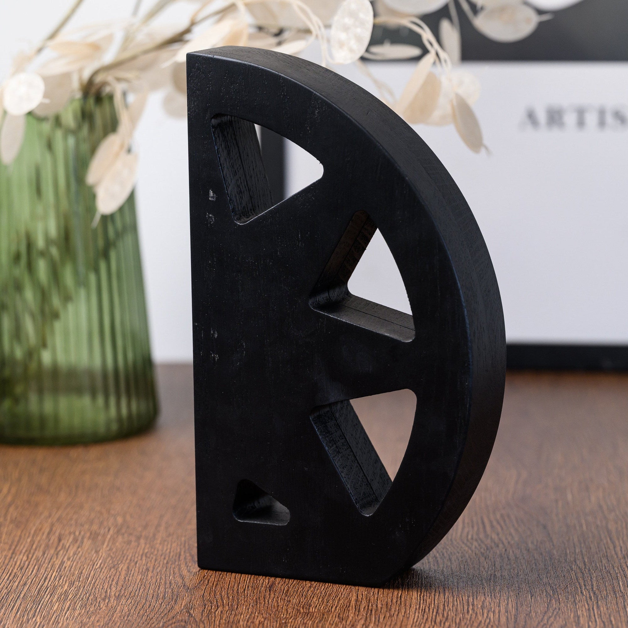 	Plain matte black reverse of the star award with three cut-out segments and no printed detail