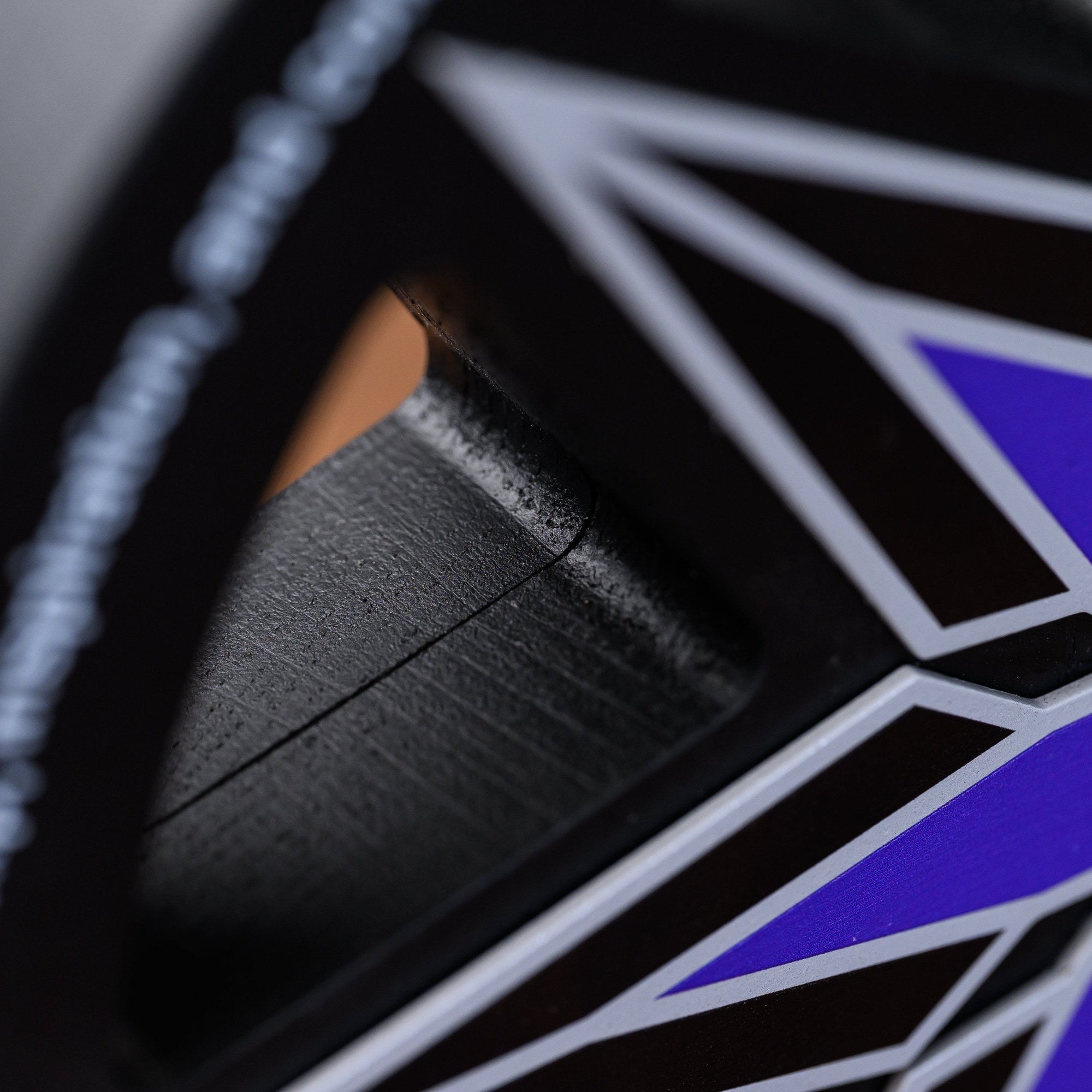 Macro of a star point meeting a cut-out opening, showing the layered depth of the award body