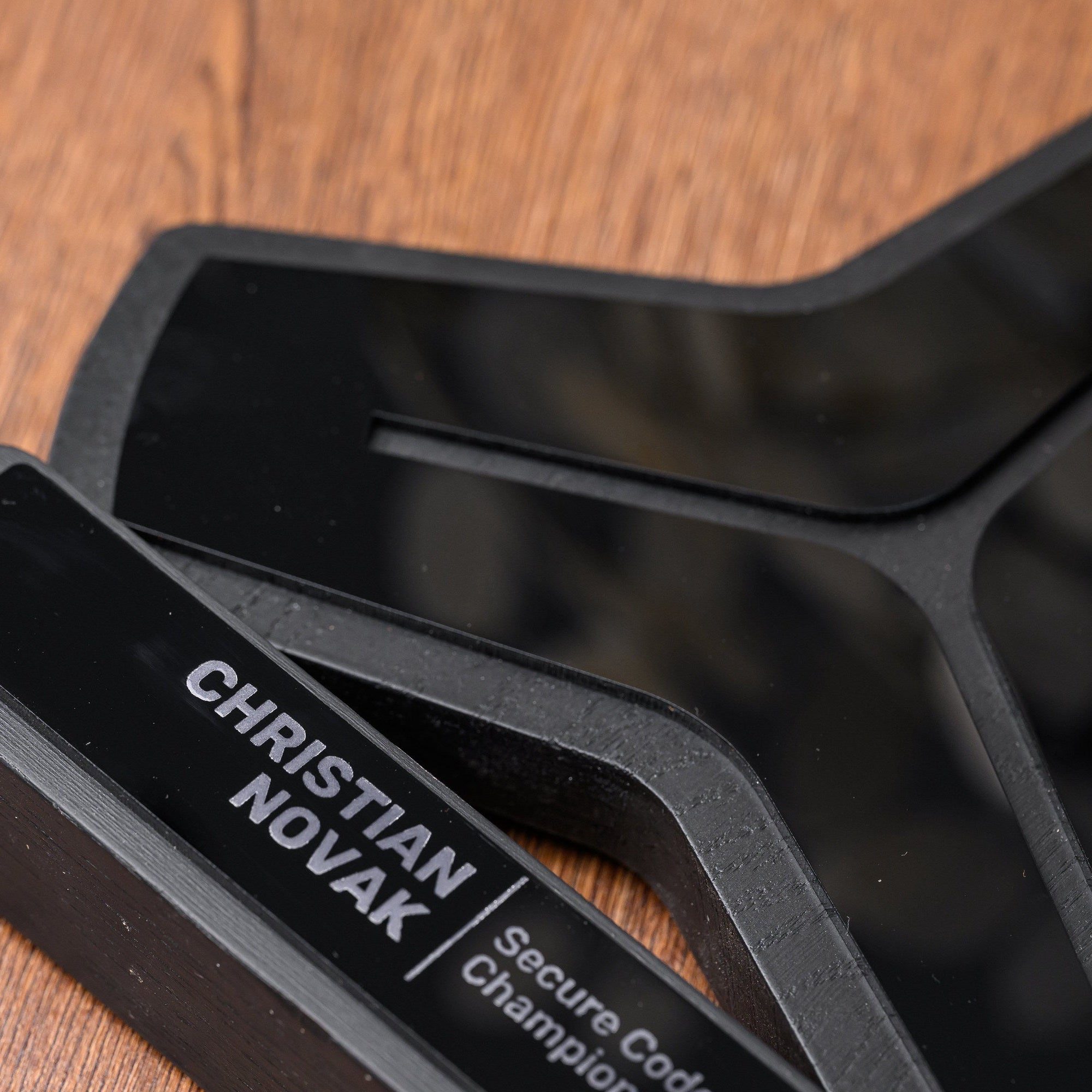 Detail of the laser engraved acrylic nameplate carrying the recipient name and award category