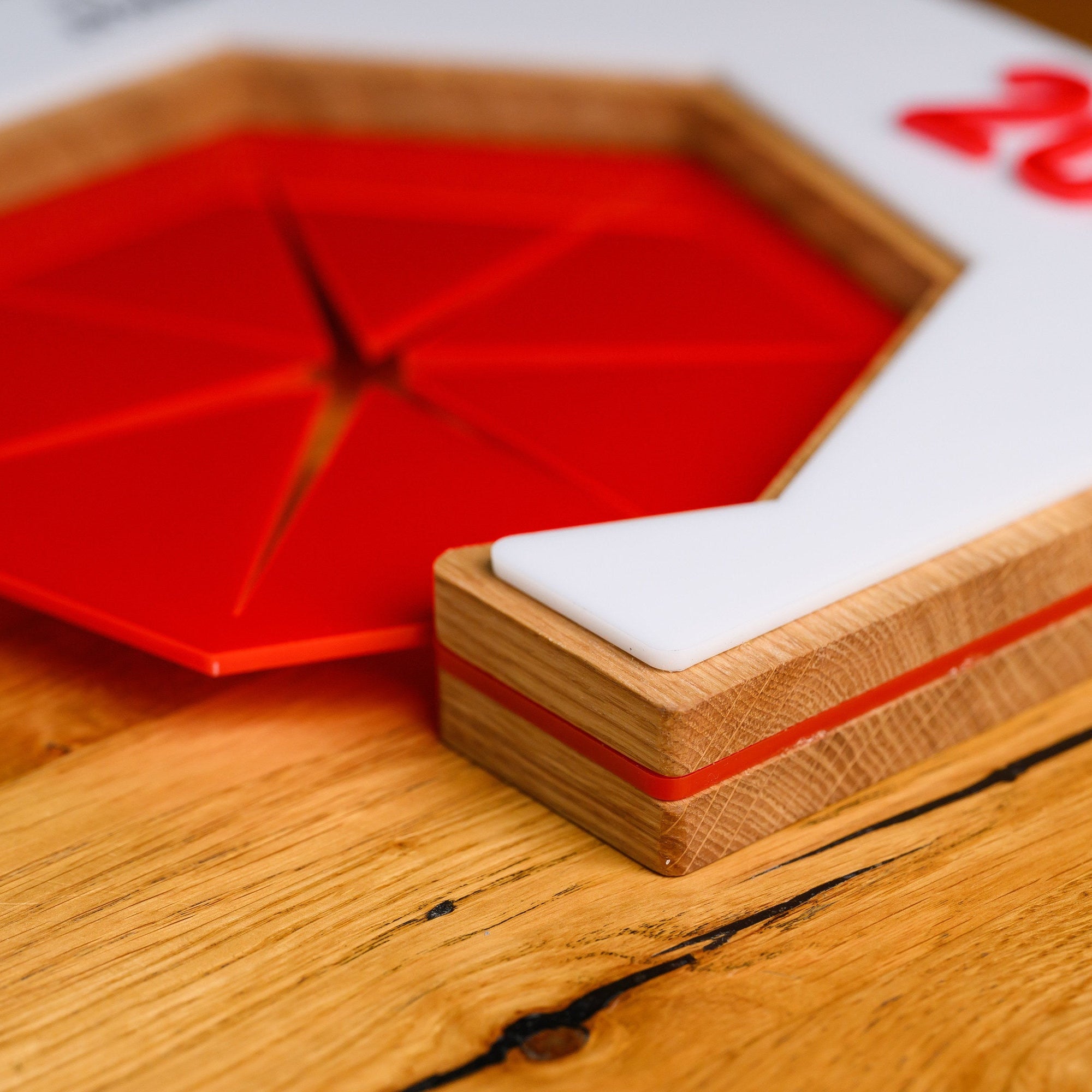 Edge detail of the award plaque with a fine coloured acrylic seam running between the oak layers