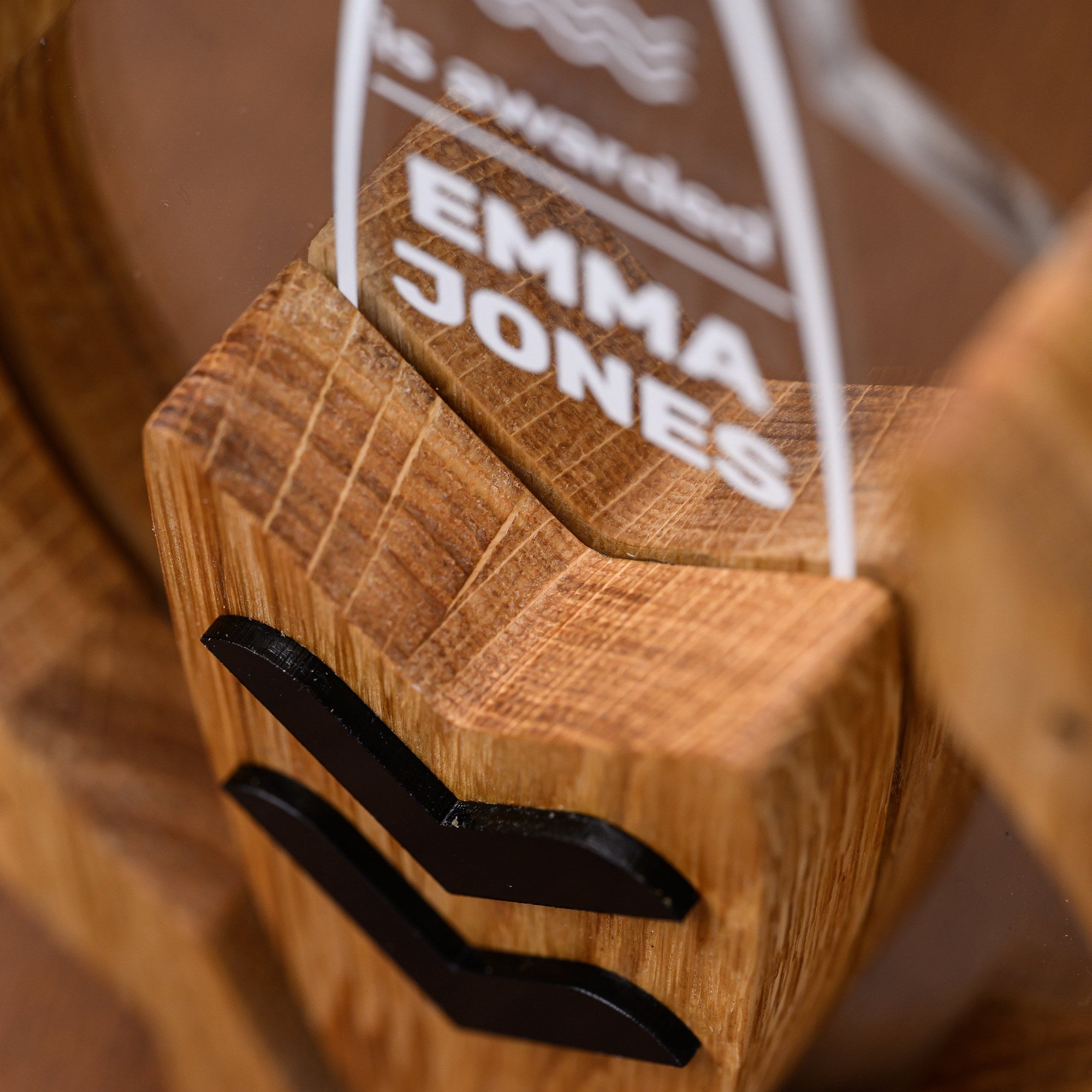 Detail of the UV printed recipient name on the acrylic board seated in the oak surfboard holder