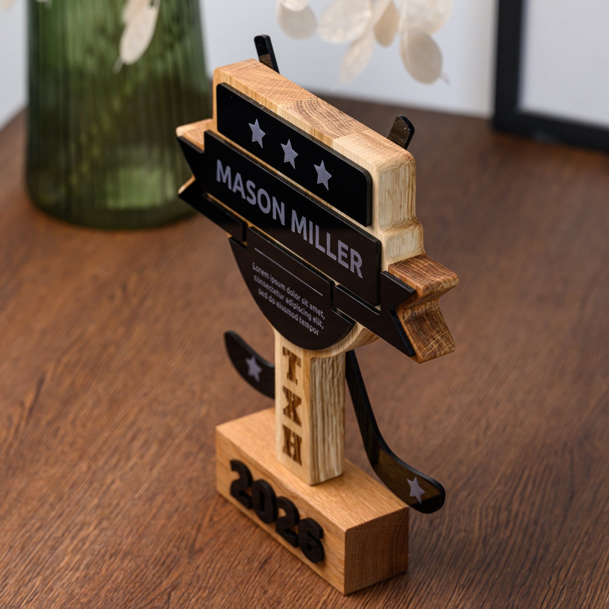 Three-quarter view of the oak hockey trophy showing the layered banner and the depth of the cut-outs