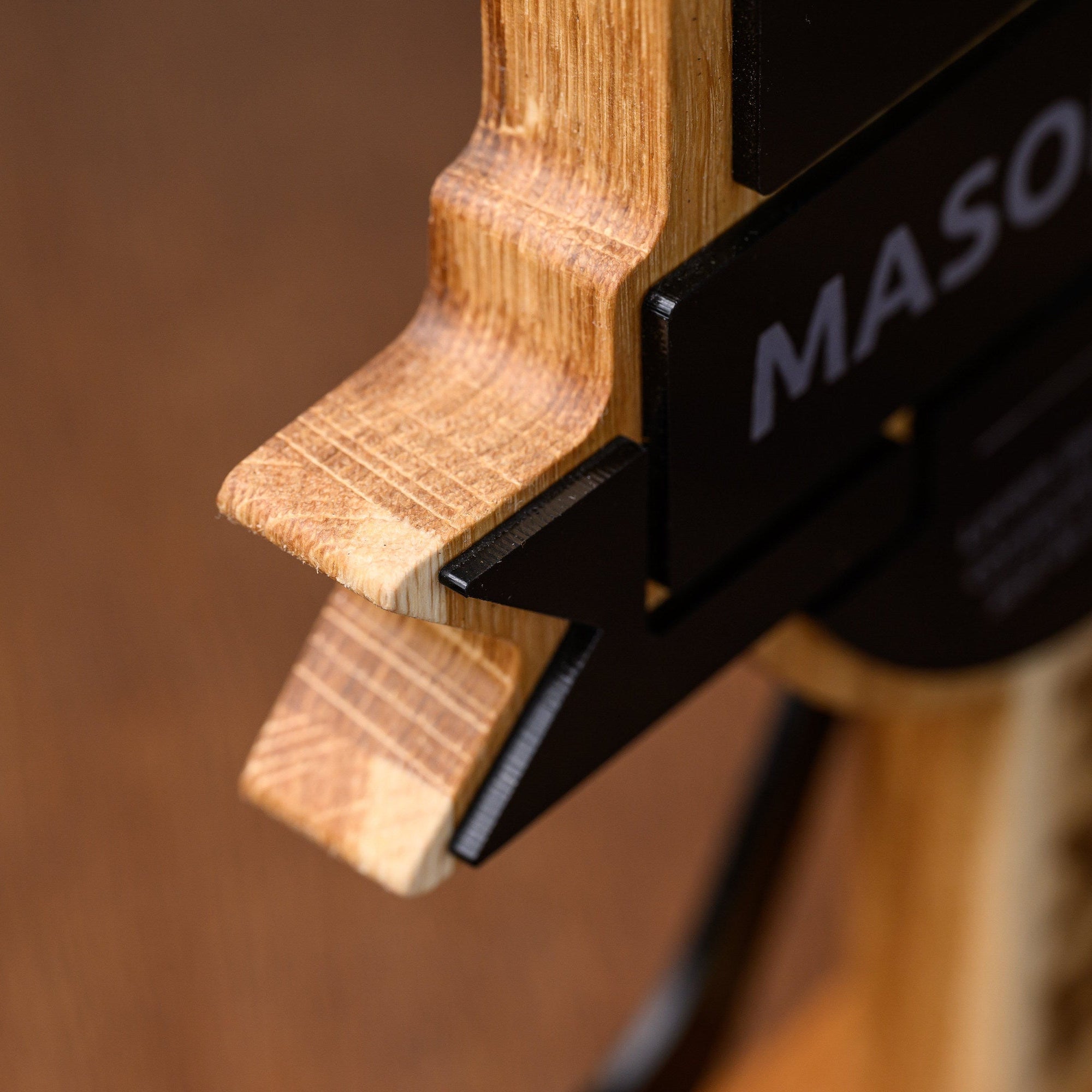Detail of the banner tail where the black acrylic overlay steps away from the shaped oak beneath
